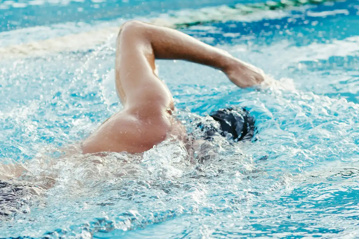Swimmer training front crawl in a pool lane