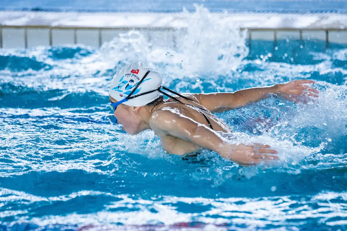 Swimmer mid-stroke during technique coaching session